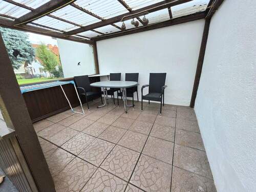 Überdachte Terrasse hinter Garagen - 