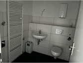 modernes Badezimmer mit Handtuchheizkörper, wandhängendem WC, großformatigen Fliesen in weiß (Wand) und dunkelgrau (Boden).PNG - 