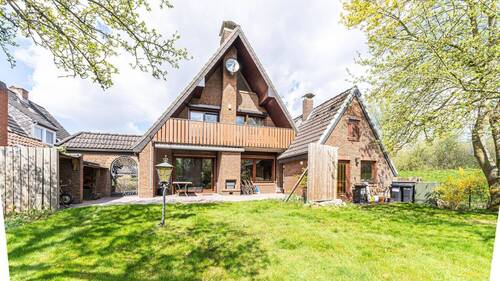 Gartenansicht - Charmantes Einfamilienhaus mit Wärmepumpe großem Südgrundstück und direkter Deichlage in Bremen-Grolland