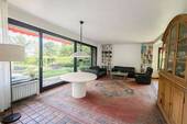 Wohnzimmer mit heller Fensterfront zum Garten - 