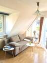 Wohnzimmer - Charmante Eigentumswohnung im 1. Obergeschoss mit Balkon und Spitzboden