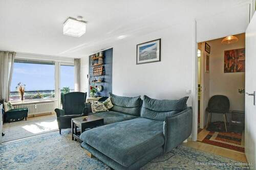 Großes, helles und freundliches Wohnzimmer mit Parkett, West-Ausrichtung und großem Balkon/großer Loggia - Alpenblick, 2-Zi., ruhige Lage, München-SOLLN mit Top-Schwimmbad, Keller und Stellplatz (optional)