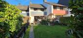 Hausansicht_hinten - Gepflegtes Reihenmittelhaus mit großer Terrasse und liebevoll angelegtem Garten zu verkaufen