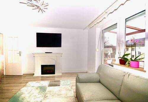 Wohnzimmer mit Zugang zum Südbalkon - 2 Zimmer Etagenwohnung in München