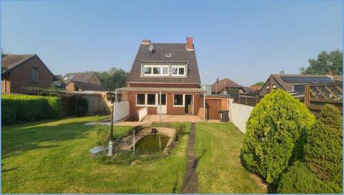 Gartenansicht - Modernisierungsbedürftiges Ein- bis Zweifamilienhaus mit Baugrundstück in Rommerskirchen-Butzheim