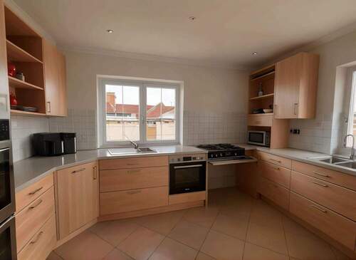 Moderne Einbauküche mit Gasherd und Panoramafenstern - Lichtdurchfluteter Kochbereich mit optimaler Arbeitsplattenausstattung - 