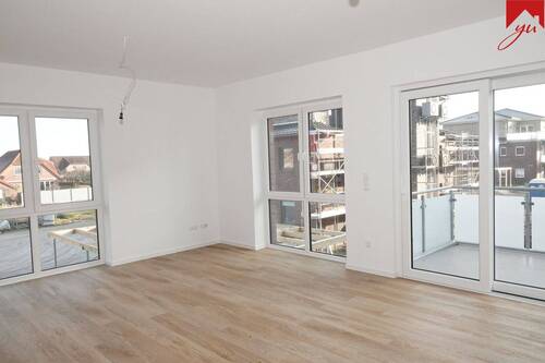 Wohn- und Essbereich mir Zugang zum Balkon - Lichtdurchflutete Obergeschosswohnung in zentraler Lage von Wiesmoor! Neubau- Erstbezug