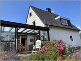Ansicht mit Wintergarten - Einfamilienhaus mit 166,00 m² in Steinhagen zum Kaufen