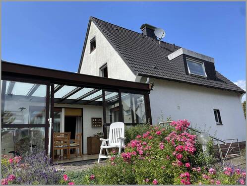 Ansicht mit Wintergarten - Einfamilienhaus mit 166,00 m² in Steinhagen zum Kaufen