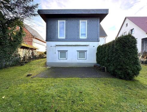 Gartenansicht - Nicht vermietetes Einfamilienhaus mit Einliegerwohnung und Garagen in Top Wohnlage