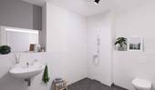 Ein modern gefliestes Badezimmer mit bodengleicher - 