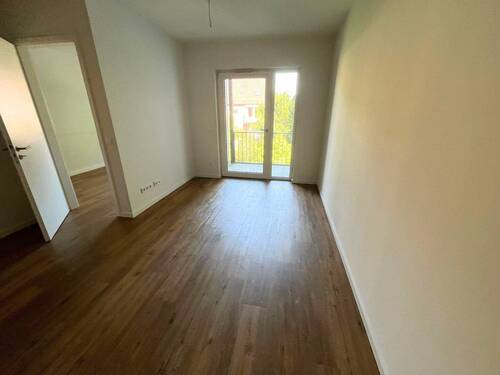 Ansicht I: Wohn- und Esszimmer mit offenem Küchenbereich - 2-Zimmer-Neubauwohnung mit BALKON und EBK in Hamburg-Langenhorn