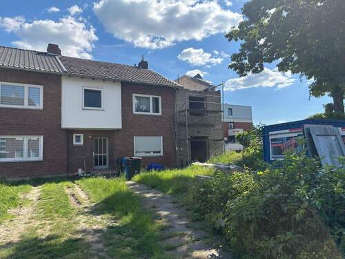 Straßenansicht - Zweifamilienhaus mit Anbau im Rohbauzustand