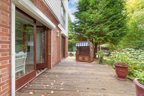 Weitläufige Holzterrasse mit Blick in den Garten - 