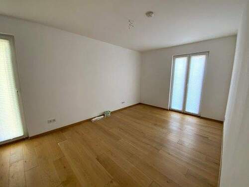 Schlafzimmer, weiß gestrichen mit Holzboden und bodengleichen Fenstern - Etagenwohnung mit 92,30 m² in Vellmar zur Miete