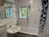 Badezimmer mit Fenster und Wanne - 
