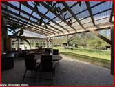 überdachte Terrasse mit Blick in den Garten - 