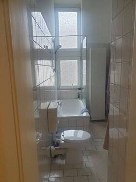 Badezimmer mit großem Fenster und Badewanne - 