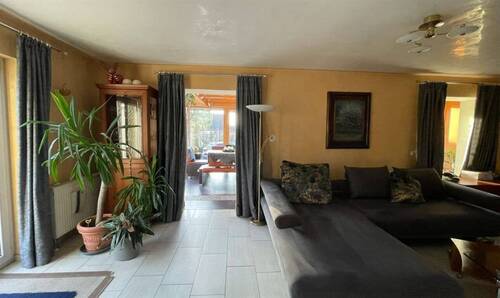 Wohnzimmer mit Blick zum Wintergarten - 