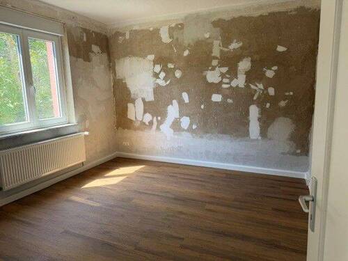 Kinderzimmer mit tapetenfreien Wänden und braunem Vinyl-Designboden in Holzoptik - 