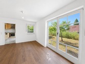 Wohnzimmer und Ausblick in den Garten - 2 Zimmer Terrassenwohnung zum Kaufen in Eibelstadt