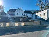 Foto - Einfamilienhaus mit Lagerhalle und Baugrundstück