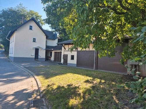 Foto - Kleines, freistehendes Haus mit Nebengebäuden