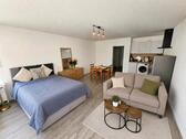 Foto - Modern möblierte 1-Zi.-Wohnung mit TG-Platz