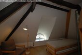 Dachgeschoss-Schlafzimmer mit Spitzbogenfenster und Balkenwerk - 